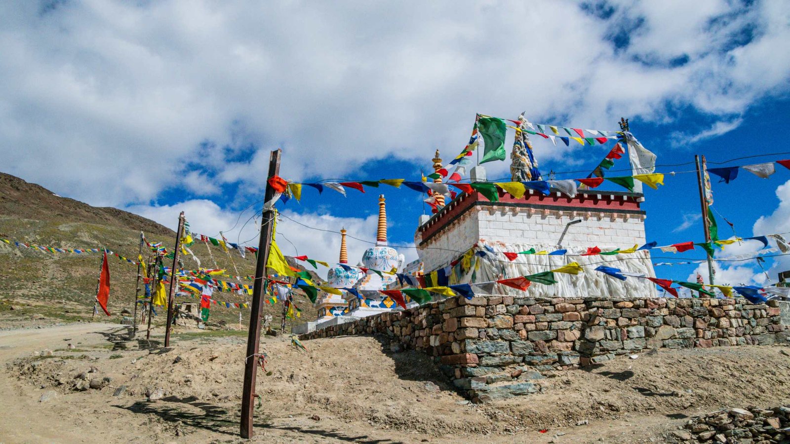 Kunzum Pass road trip view with rugged landscapes, blue skies and mountain adventure