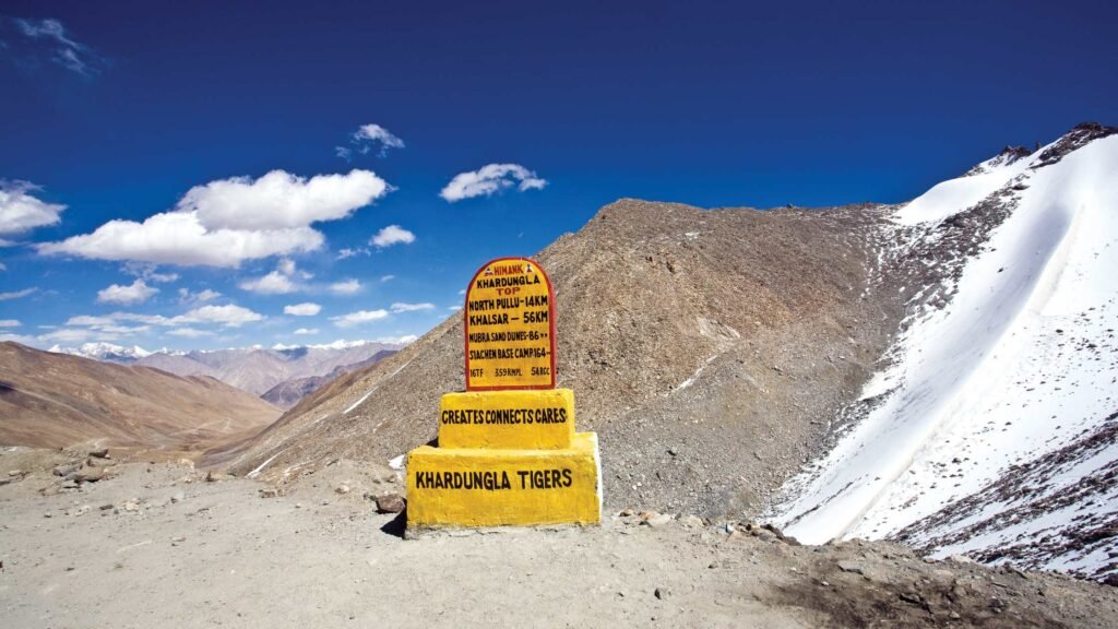 Panoramic view of Khardung La Pass Leh Ladakh featuring rugged mountains and adventure route